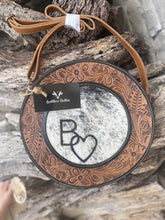 Load image into Gallery viewer, custom branded crossbody canteen purse, tooled leather detail, black and white cowhide