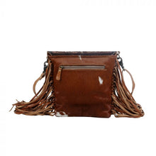 Load image into Gallery viewer, cowhide crossbody purse with tooled leather flap and brown leather fringe