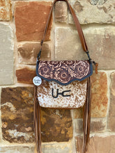 Load image into Gallery viewer, custom branded cowhide crossbody purse with tooled leather flap and brown leather fringe 
