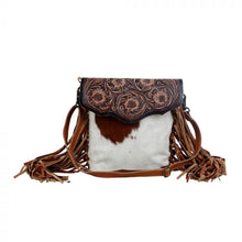 Load image into Gallery viewer, cowhide crossbody purse with tooled leather flap and brown leather fringe 
